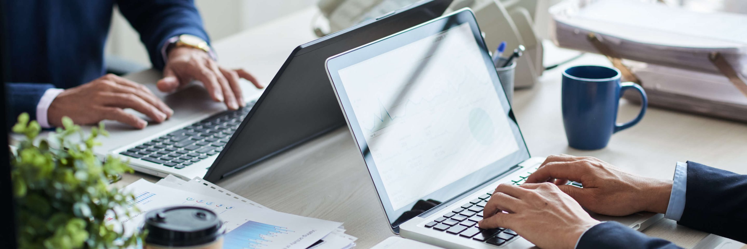 Side view cropped unrecognizable business people working common desk