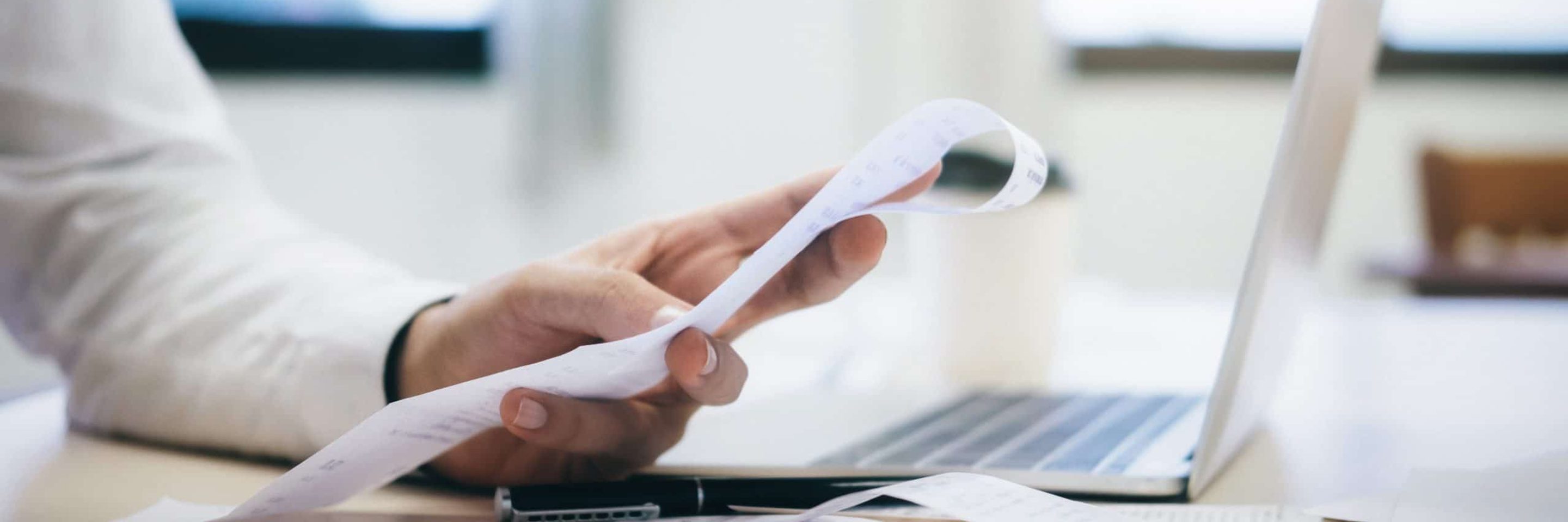 Financial officers calculate expenses from cash bi VJJLX5 G scaled
