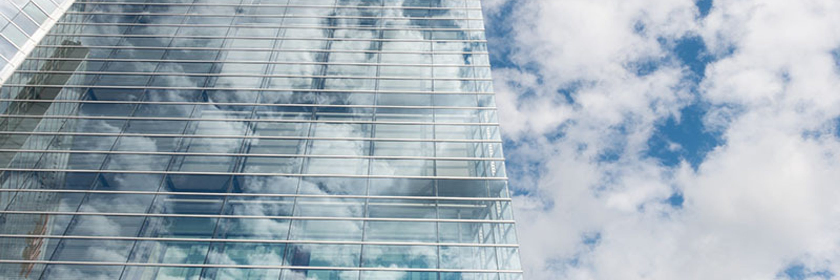 Bottom view of clear glass building under blue cloudy sky 800 x 533 px