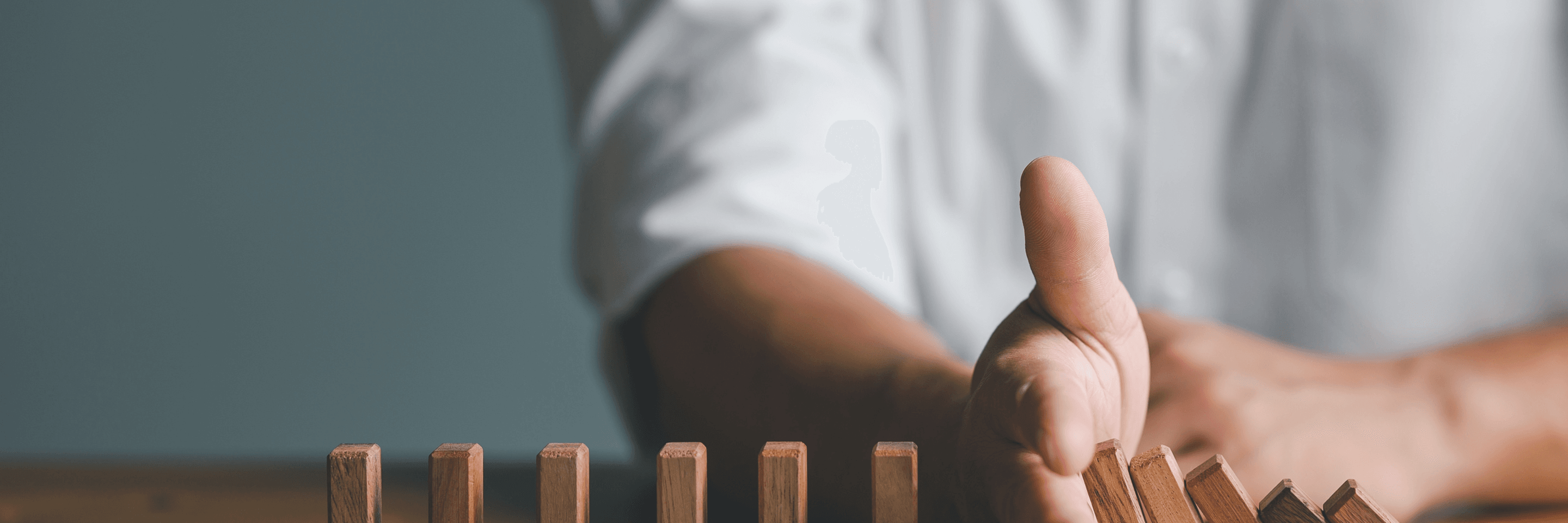 Hand stopping domino risks