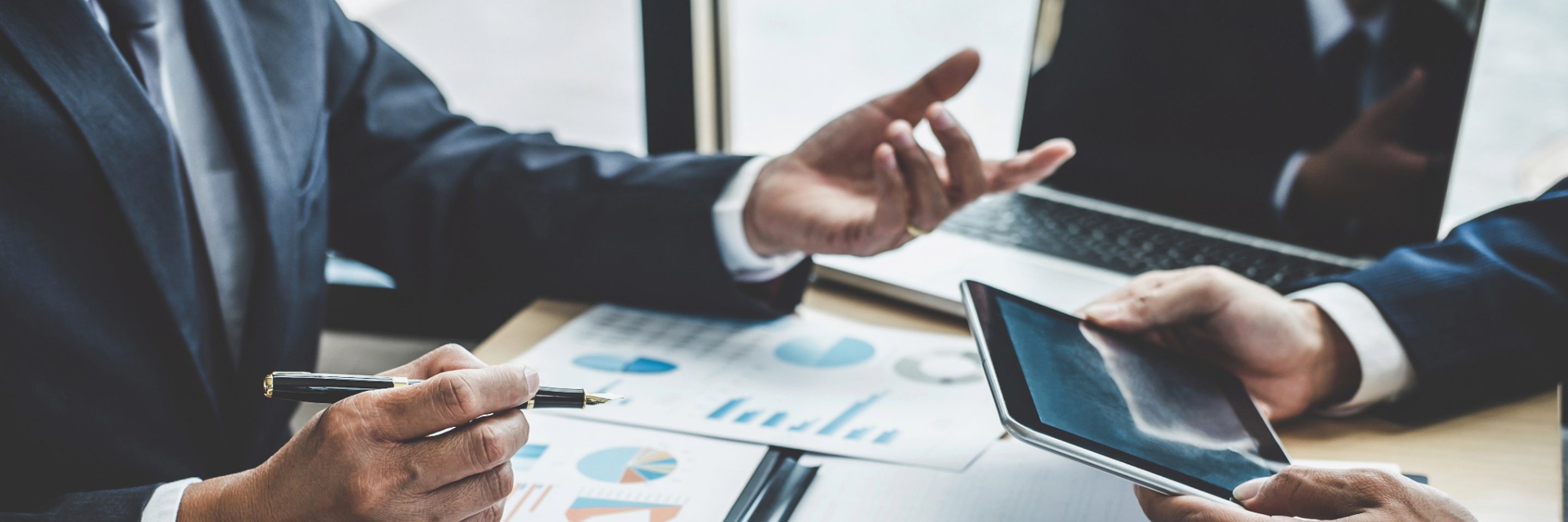 hands calculator table paper files graphs tables corporate discuss meeting