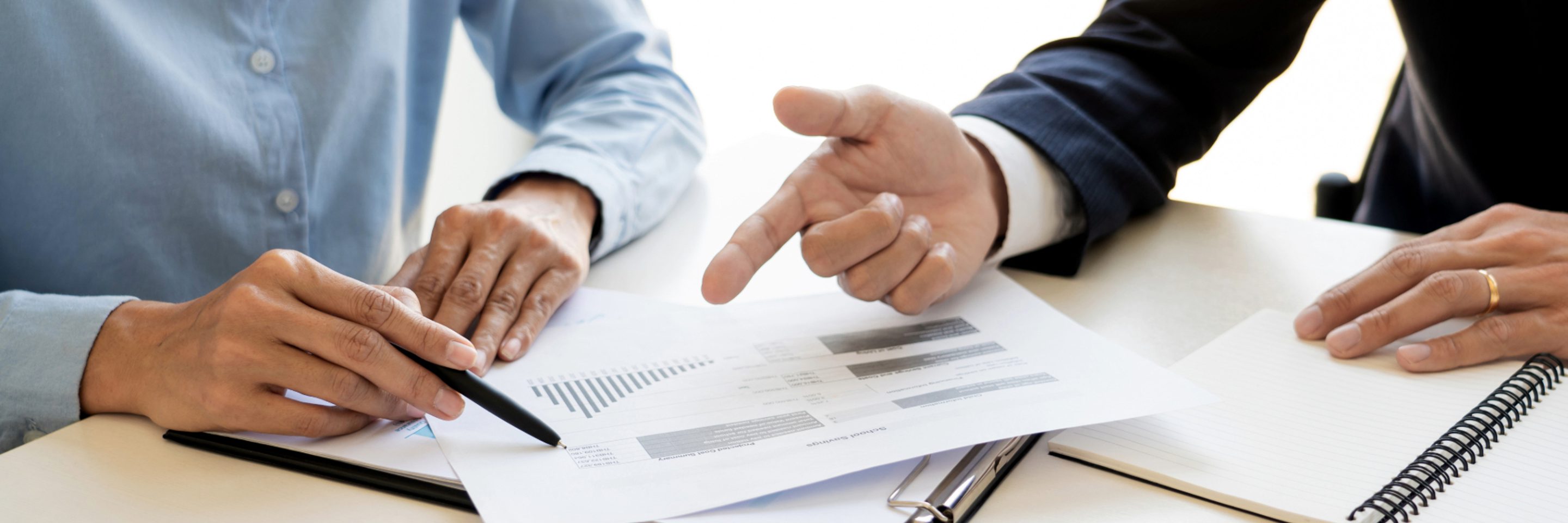 People discussing meeting room corporate sheet calculator graph chart